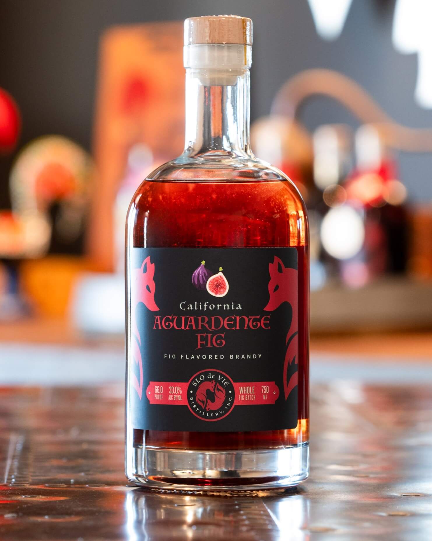 Bottle of Aguardente Fig flavored brandy on copper table top - close up shot