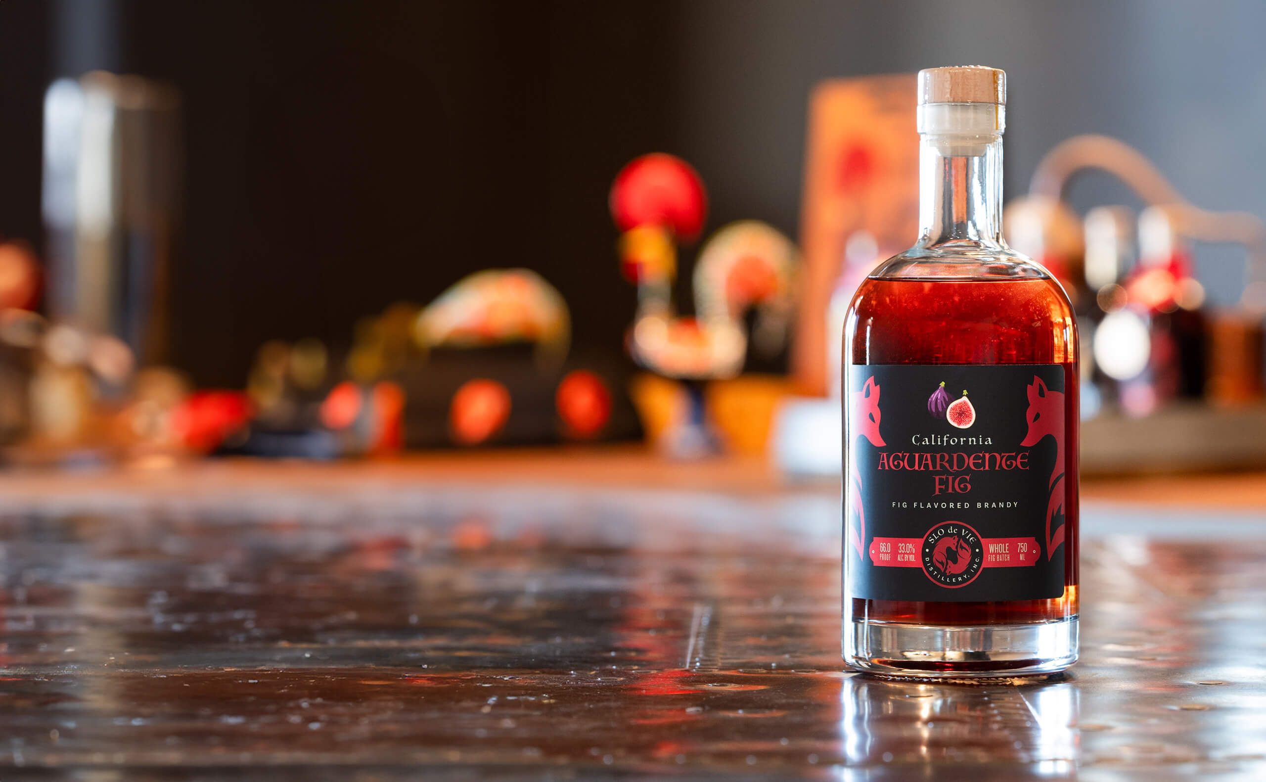 Bottle of Aguardente Fig flavored brandy on copper table top