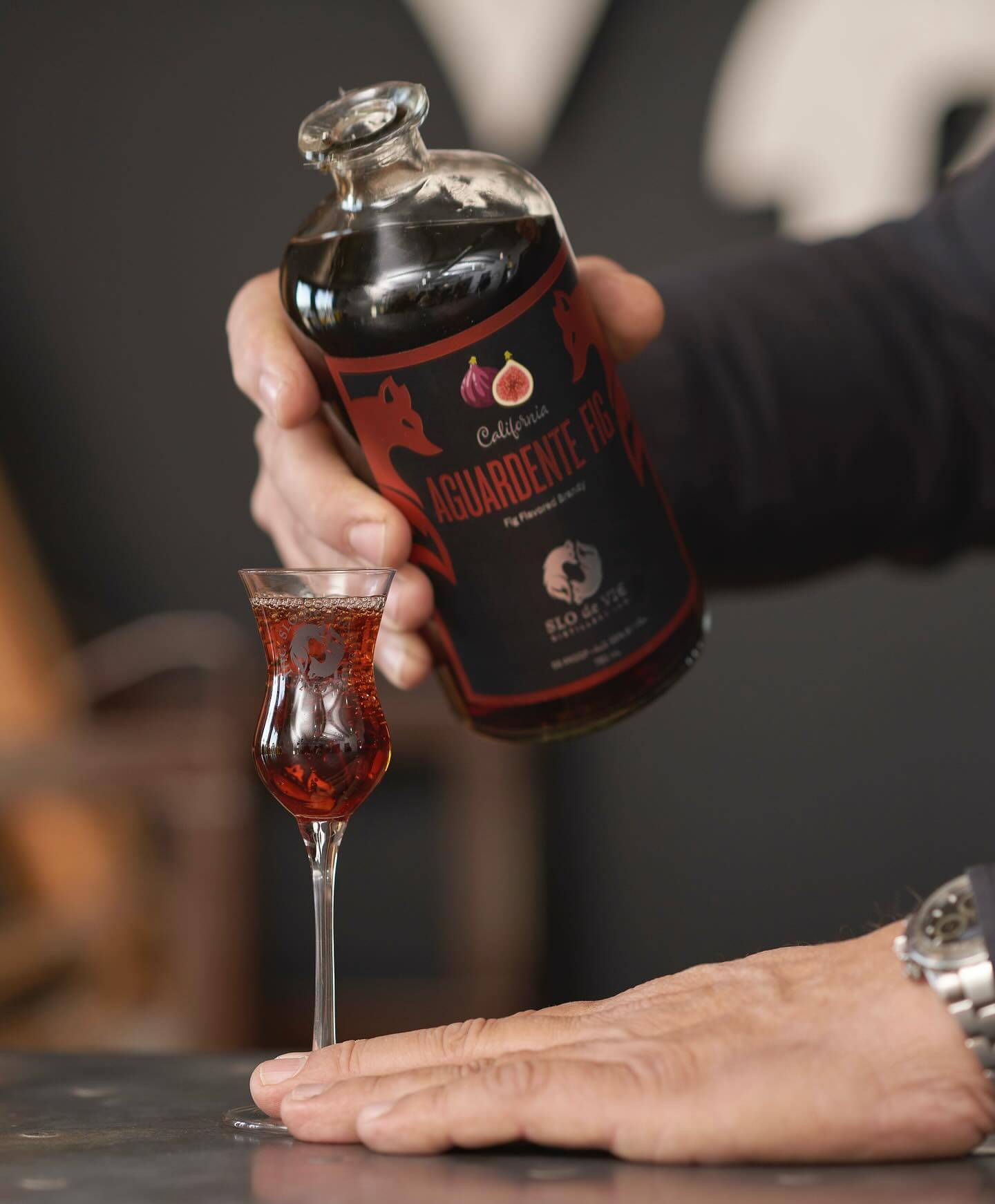 Bottle of Aguardente Fig flavored brandy on copper table top - close up shot